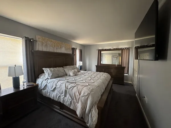 a bedroom with a bed and a mirror