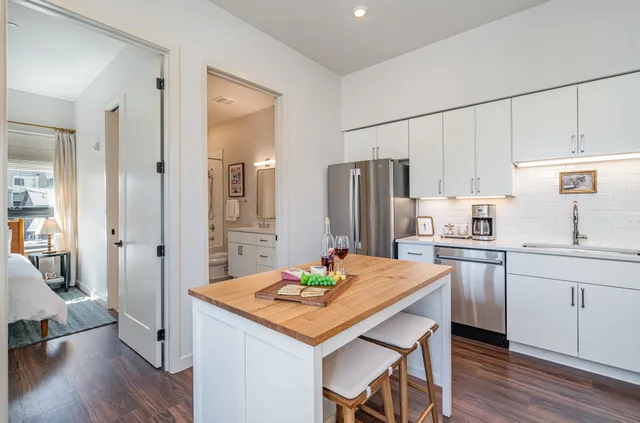 a kitchen with a stove a sink and a refrigerator