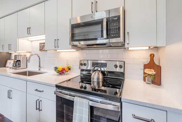 a kitchen with a sink a counter and a refrigerator