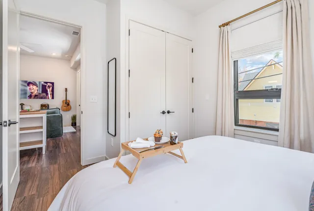 a bathroom with a double vanity sink toilet mirror and shower