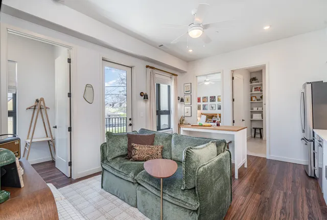 a living room with stainless steel appliances kitchen island granite countertop furniture and a kitchen view