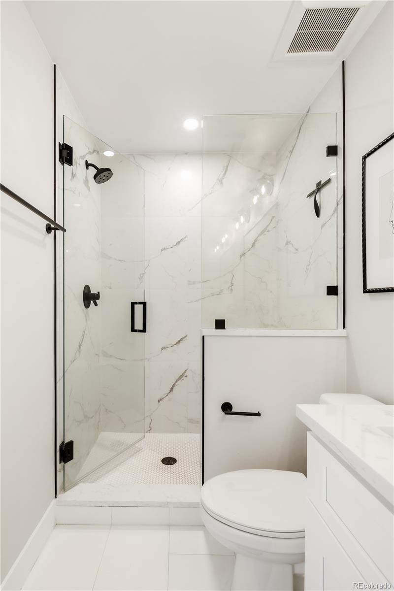 1467 Locust Street Denver, CO 80220 - Photo 11 of 23 a bathroom with a shower a toilet and a shower