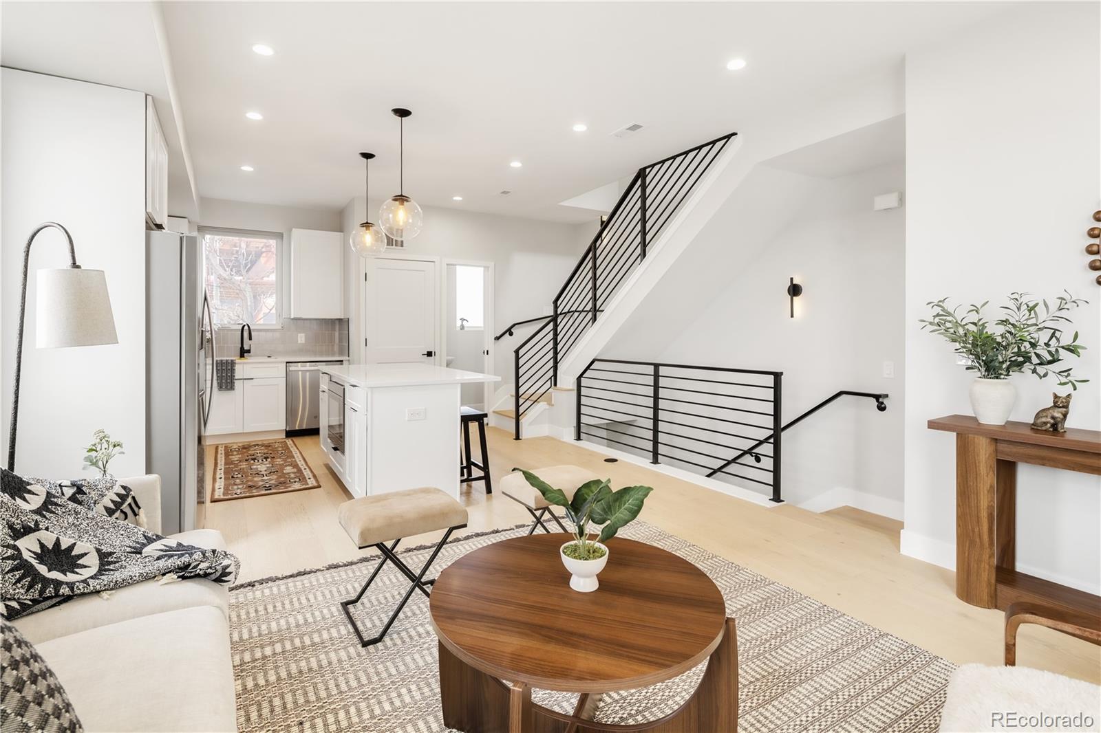 1467 Locust Street Denver, CO 80220 - Photo 12 of 23 a living room with furniture flowers and a chandelier
