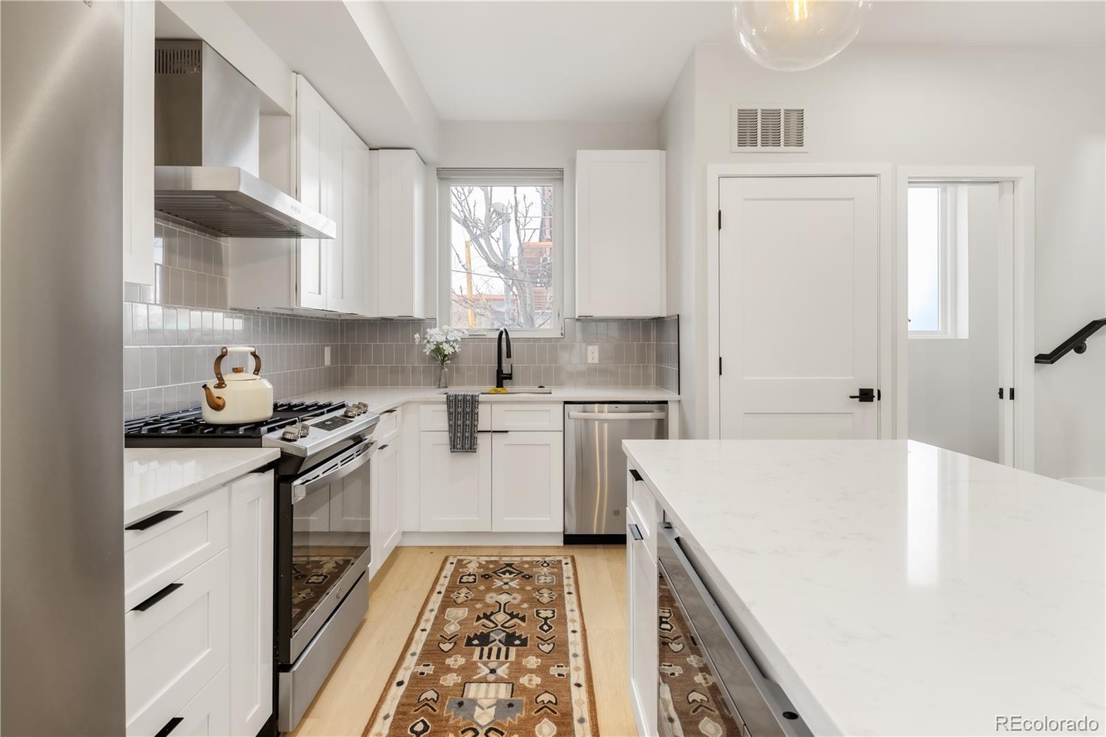 1467 Locust Street Denver, CO 80220 - Photo 13 of 23 a kitchen with a sink stove and refrigerator