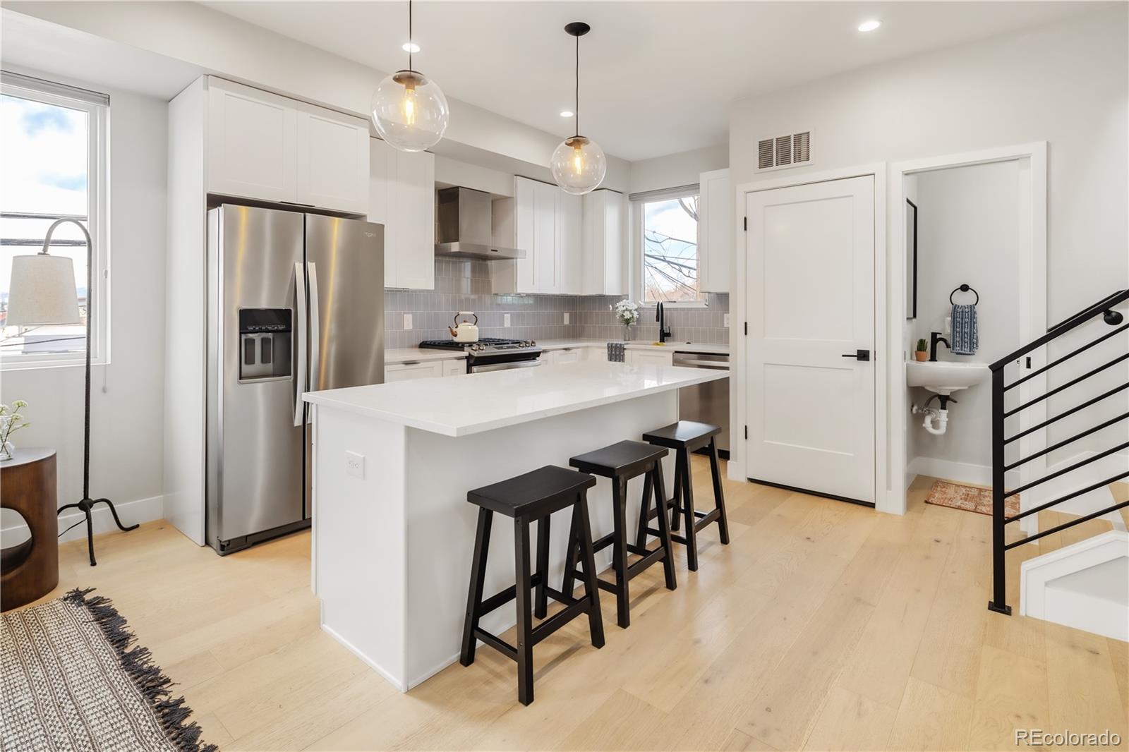 1467 Locust Street Denver, CO 80220 - Photo 14 of 23 a kitchen with refrigerator a sink and chairs