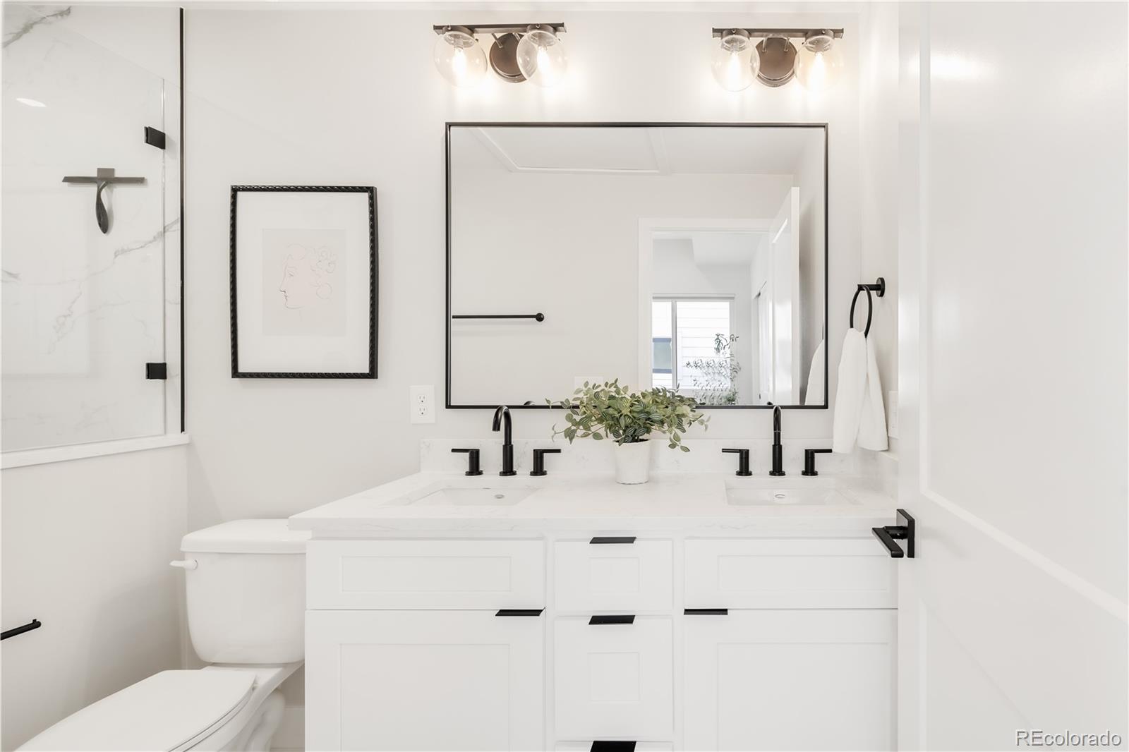 1467 Locust Street Denver, CO 80220 - Photo 15 of 23 a bathroom with a sink vanity mirror and toilet