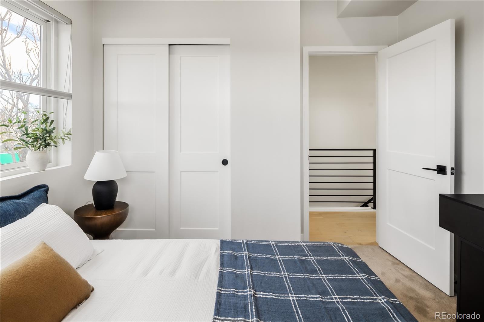 1467 Locust Street Denver, CO 80220 - Photo 20 of 23 a view of a bedroom with a bed and a potted plant