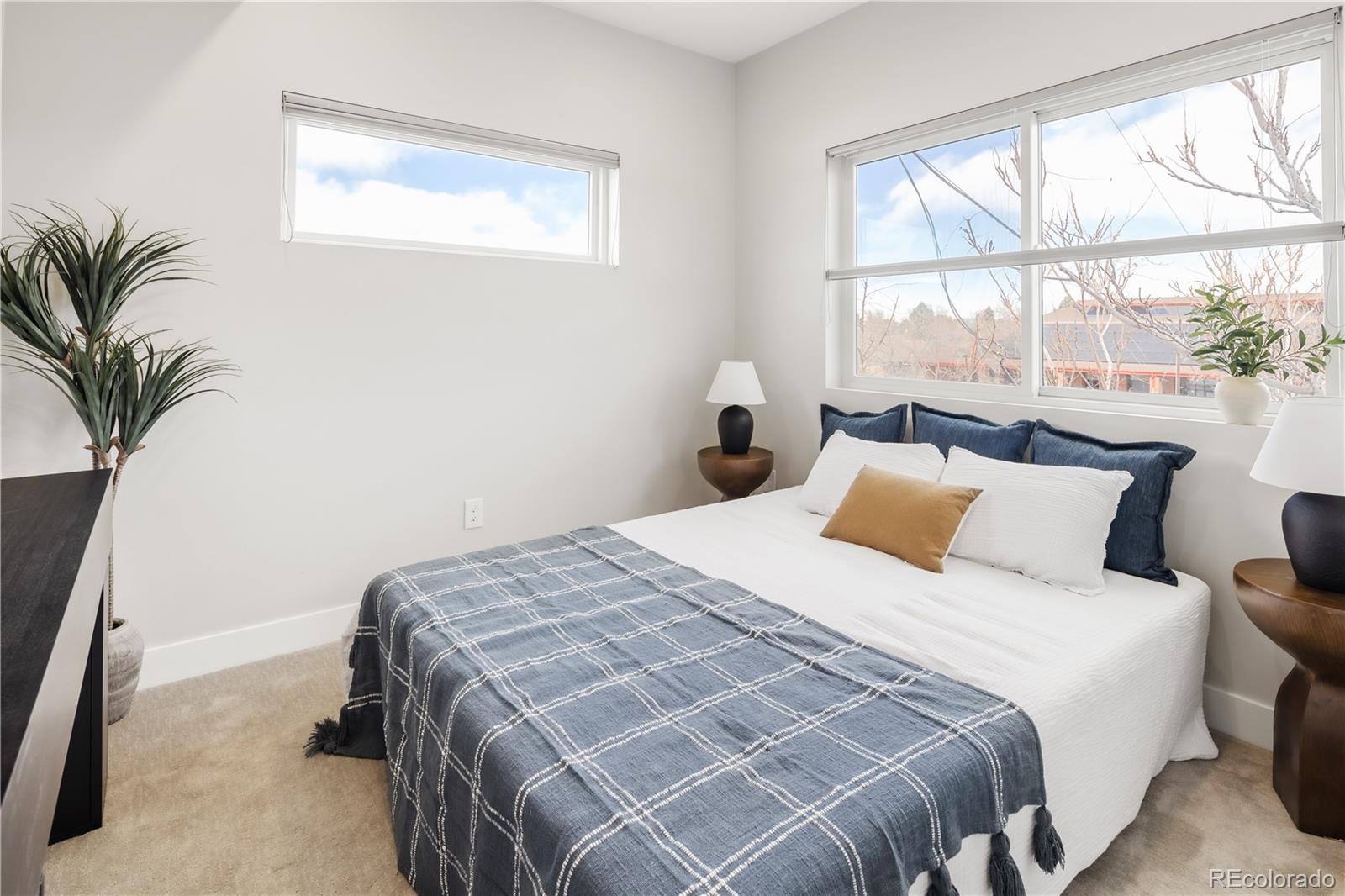 1467 Locust Street Denver, CO 80220 - Photo 5 of 23 a bed sitting in a bedroom next to a window