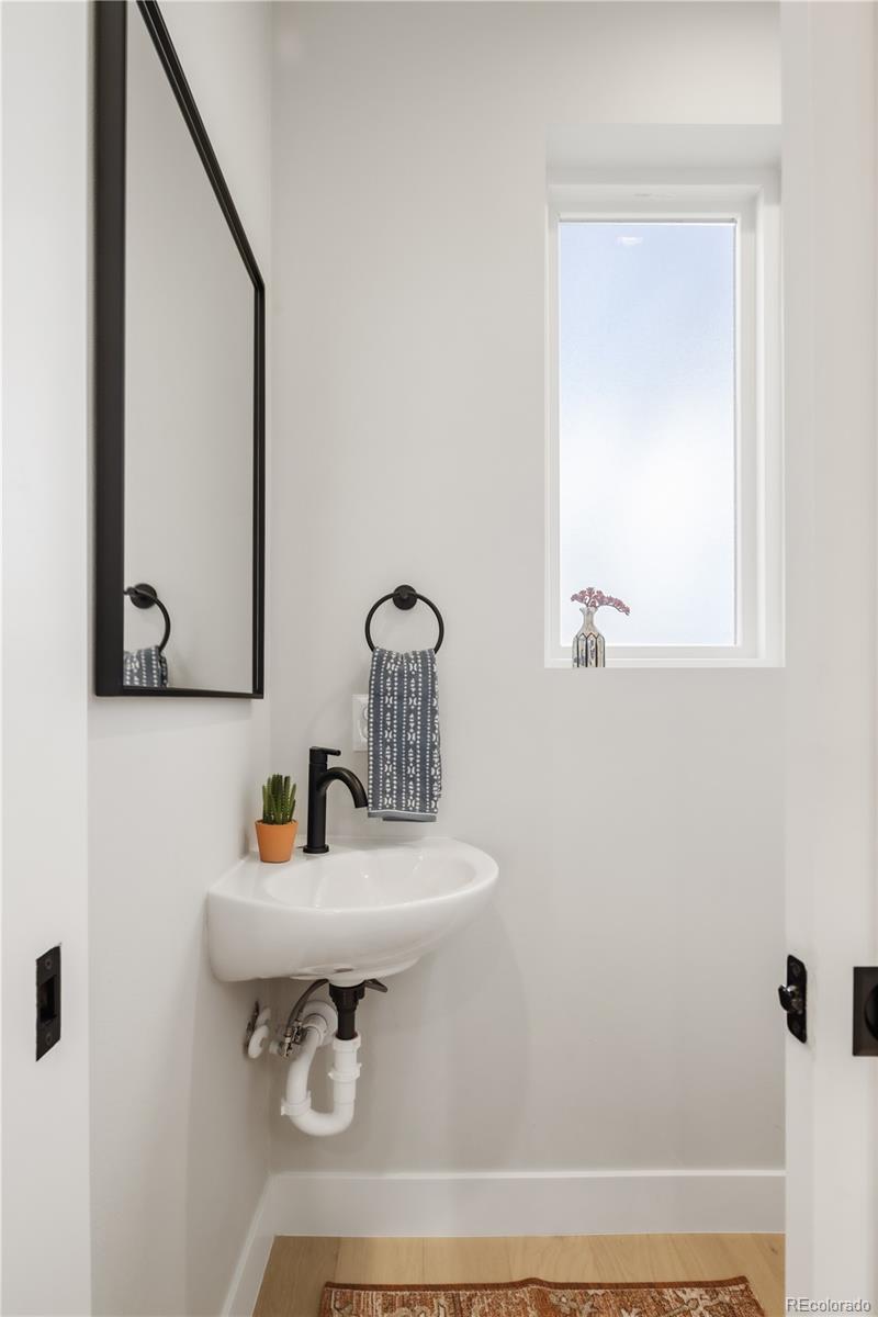 1467 Locust Street Denver, CO 80220 - Photo 7 of 23 a bathroom with a sink and a mirror