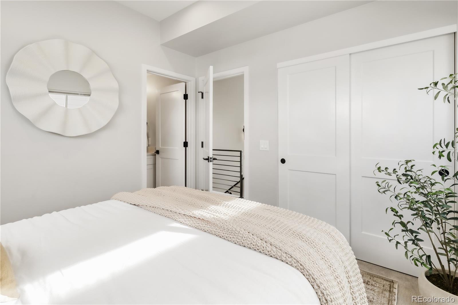 1467 Locust Street Denver, CO 80220 - Photo 10 of 23 a large white bed in a white room