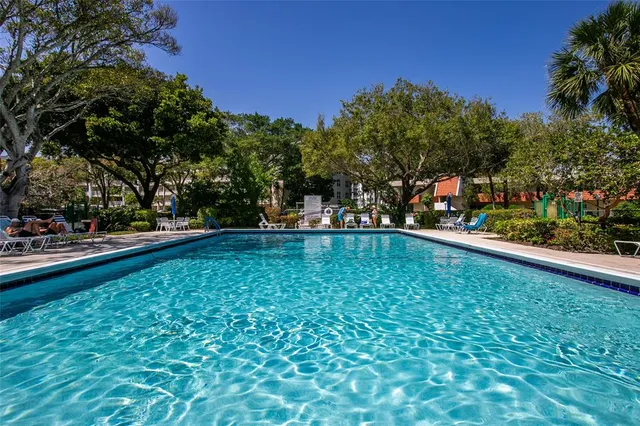 a view of swimming pool with outdoor seating and yard