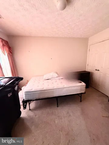 a bedroom with a bed and a night stand