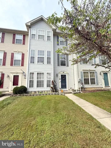 a front view of a building with a garden