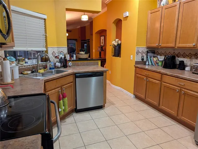 a kitchen with stainless steel appliances granite countertop a sink a stove and a refrigerator