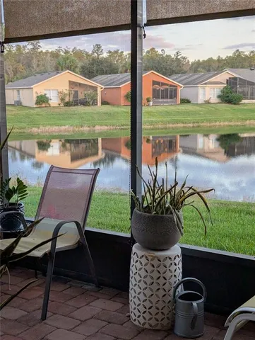 a view of a porch with furniture and a yard