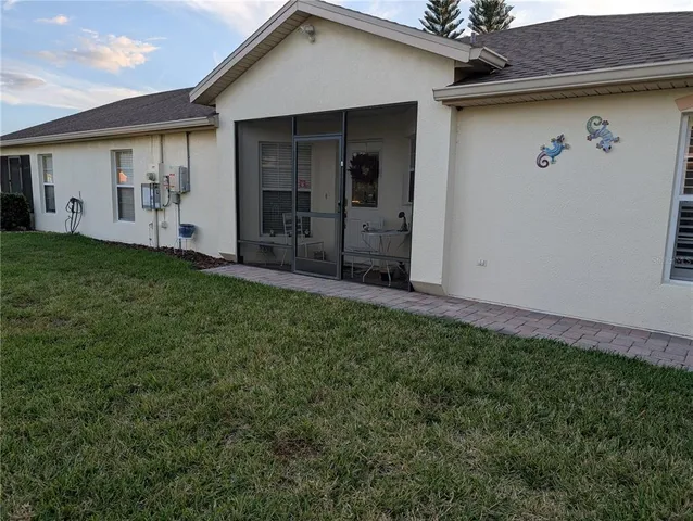 a view of a house with a backyard