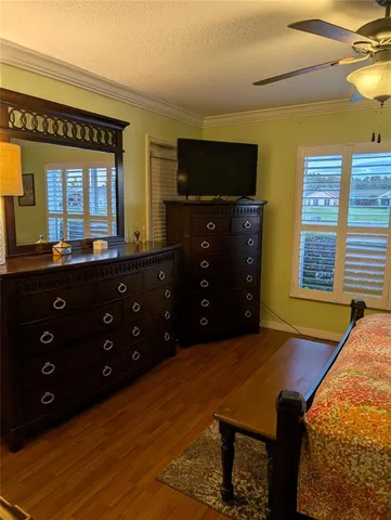a living room with a table chairs and a flat screen tv