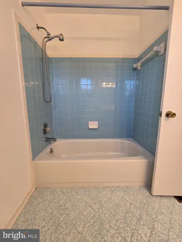 a bathroom with a bath tub and shower