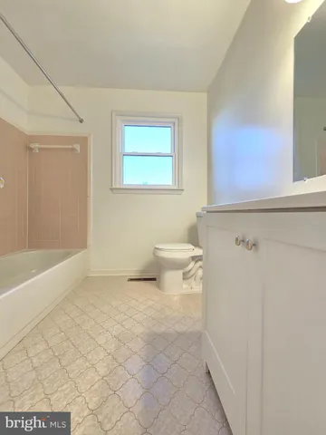 a bathroom with a toilet a sink and bathtub