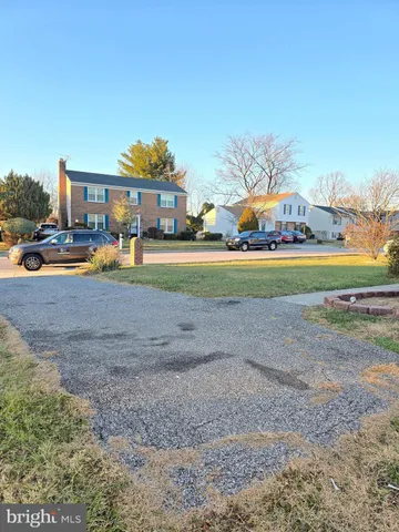 a front view of house with outdoor space and trees