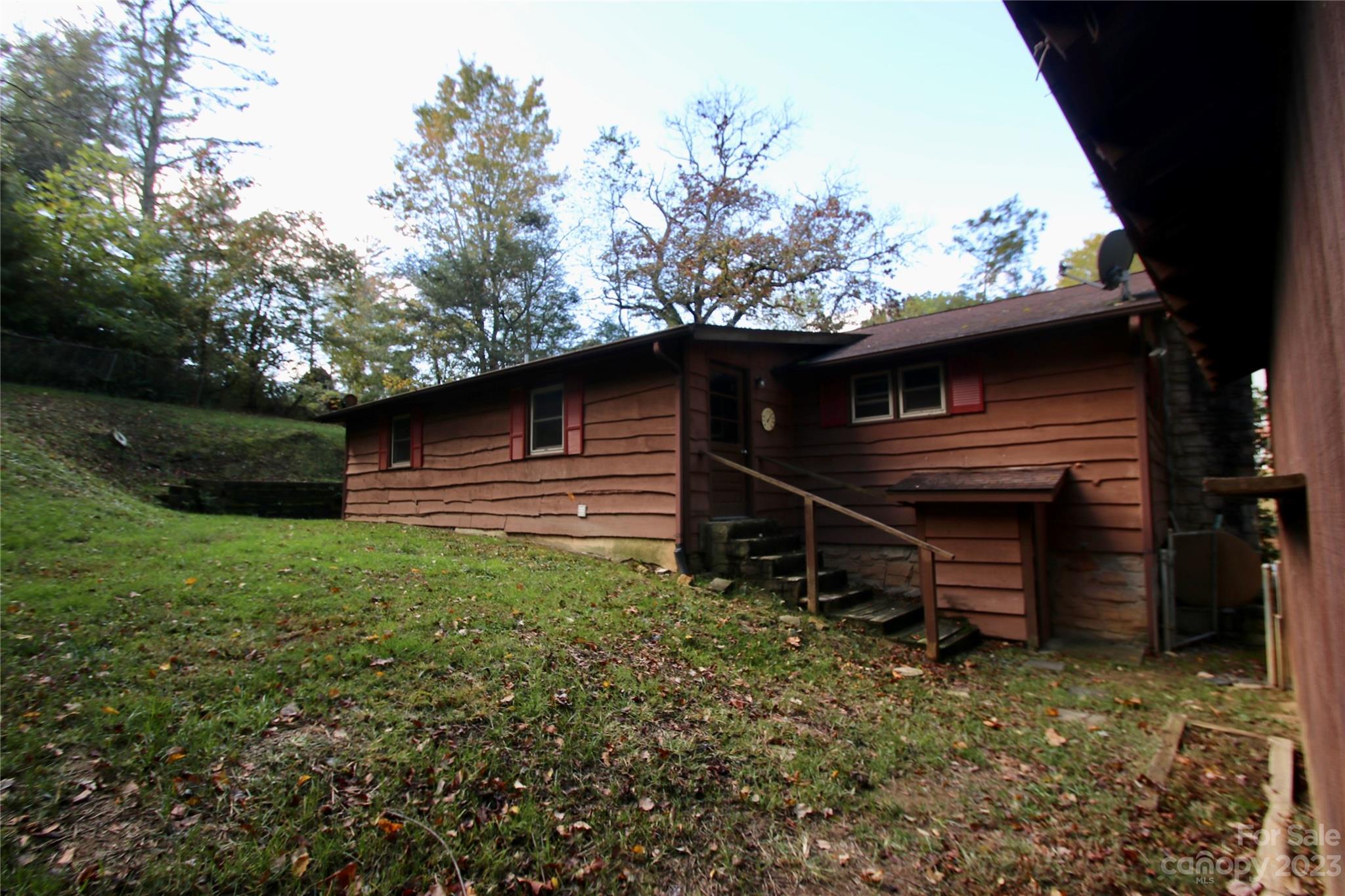 2872 Hyder Mountain Road Clyde, NC 28721 - Photo 17 of 29 a backyard of a house with lots of green space