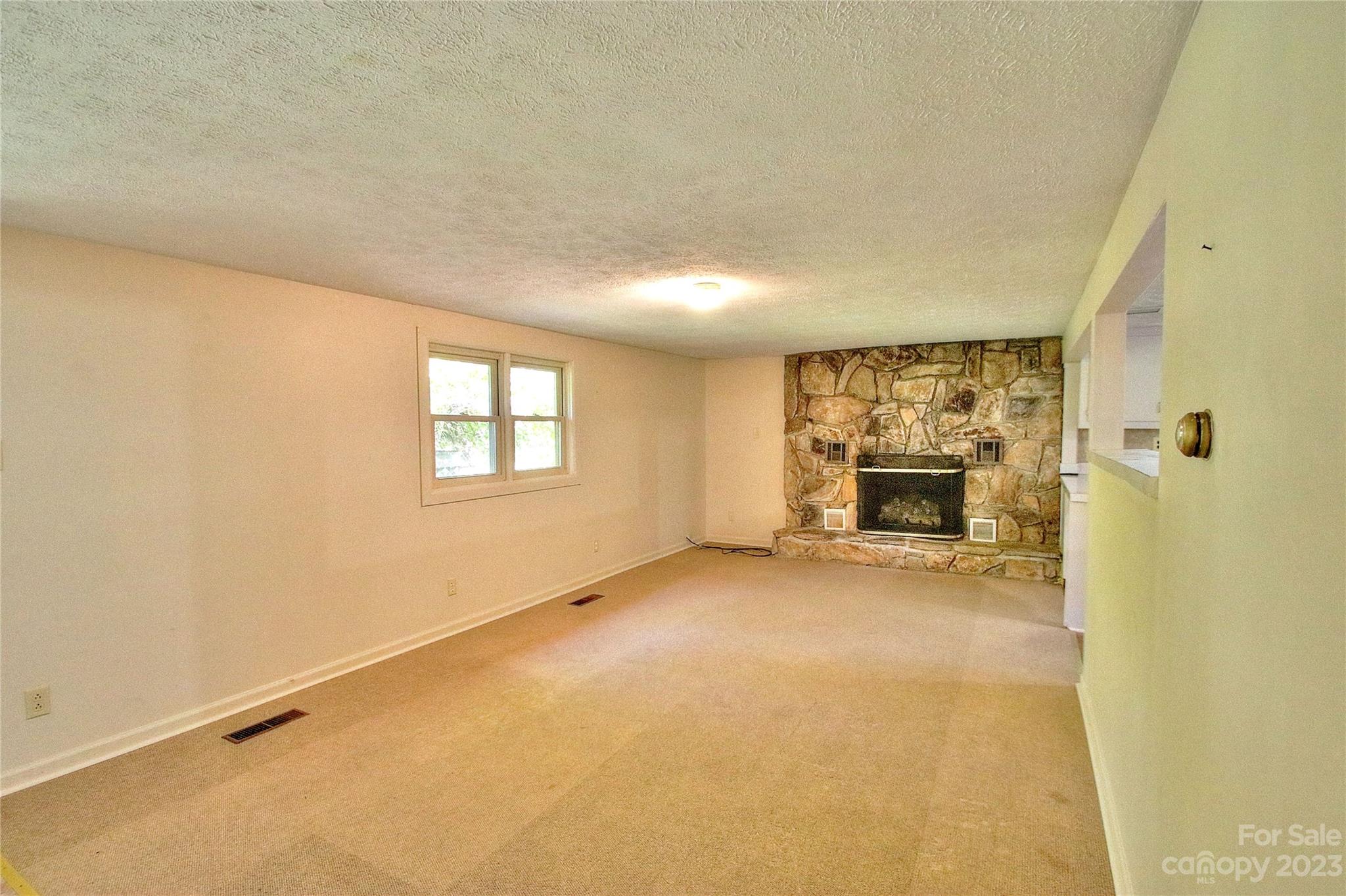 2872 Hyder Mountain Road Clyde, NC 28721 - Photo 4 of 29 an empty room with a fireplace