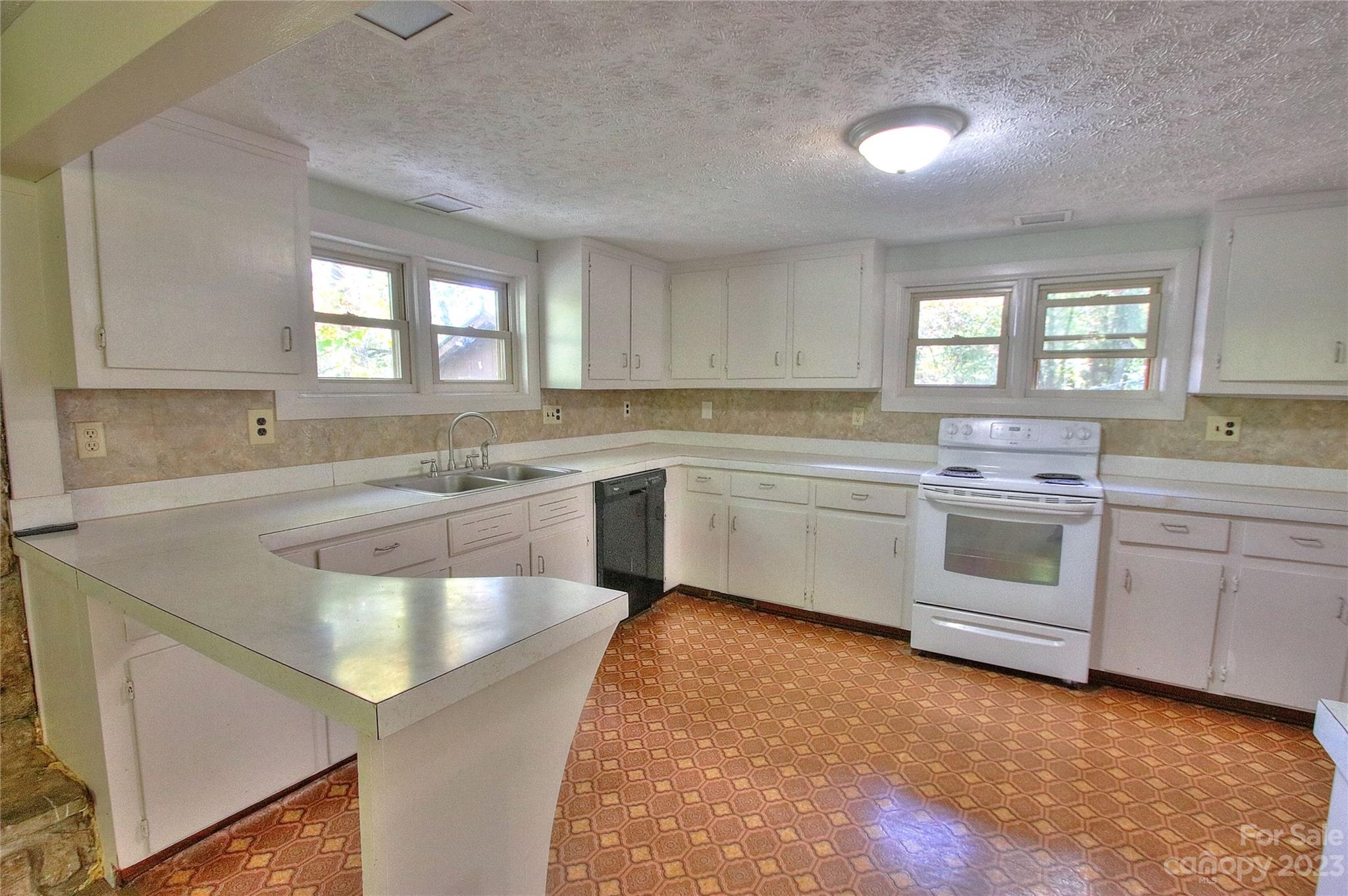2872 Hyder Mountain Road Clyde, NC 28721 - Photo 6 of 29 a kitchen with a sink stove and cabinets