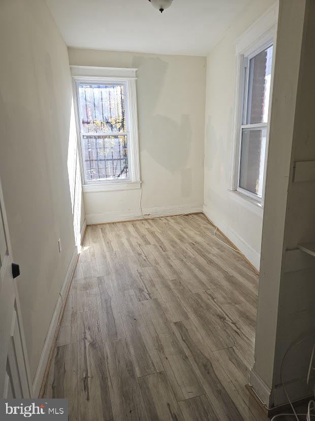 1648 Columbia Road Northwest, Unit B Washington, DC 20009 - Photo 11 of 15 a view of an empty room with wooden floor and a window