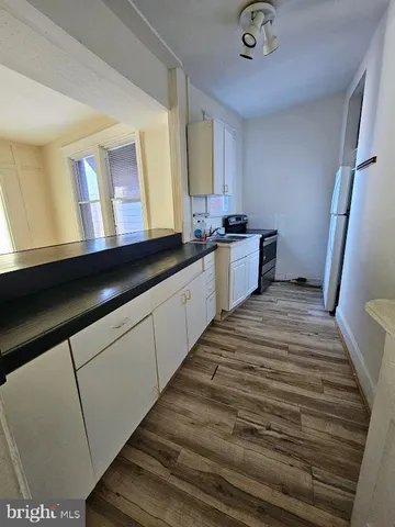 a kitchen with granite countertop a sink and a stove