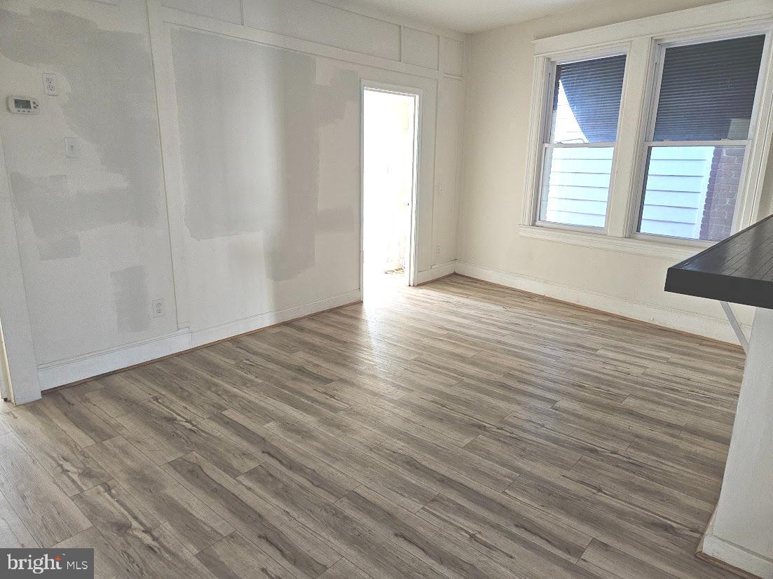 1648 Columbia Road Northwest, Unit B Washington, DC 20009 - Photo 6 of 15 a view of an empty room with wooden floor and a window