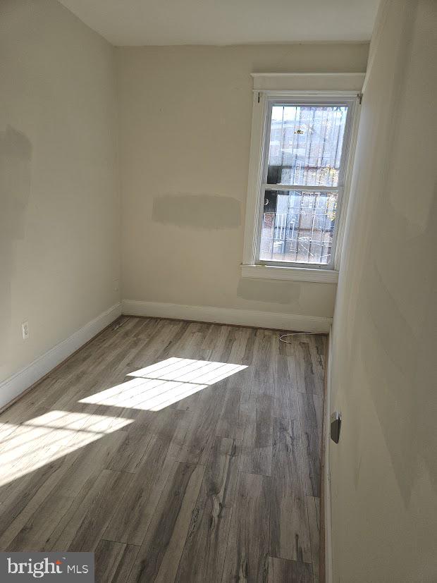 1648 Columbia Road Northwest, Unit B Washington, DC 20009 - Photo 9 of 15 an empty room with wooden floor and windows