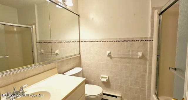 a bathroom with a toilet a sink and a shower