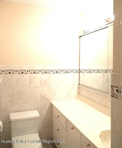 a view of a room with a white walls and wooden floor