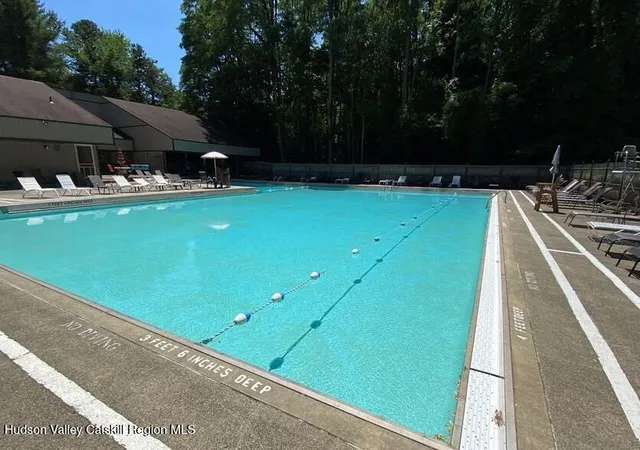 a large living room with stainless steel appliances kitchen island granite countertop a couch and a view of living room