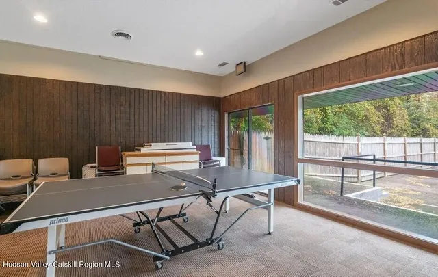 a room with pool table and windows