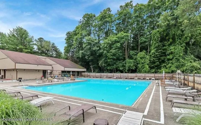 a view of a swimming pool and a yard