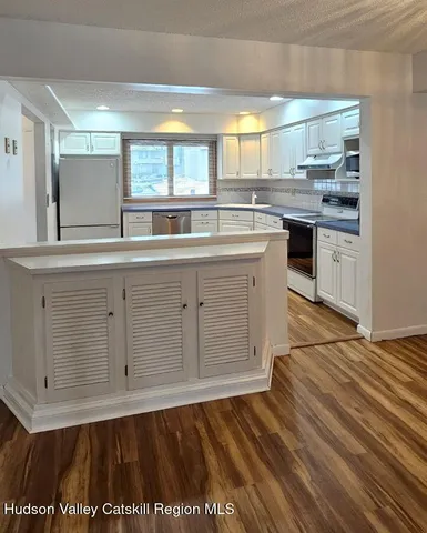 a view of a room with wooden floor and chair