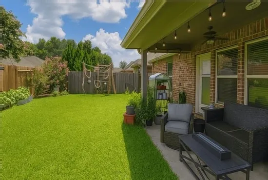 a view of house with backyard and outdoor seating