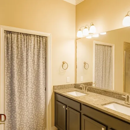 a bathroom with a double vanity sink and a mirror
