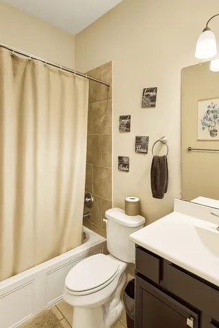 a white toilet sitting next to a bathroom sink