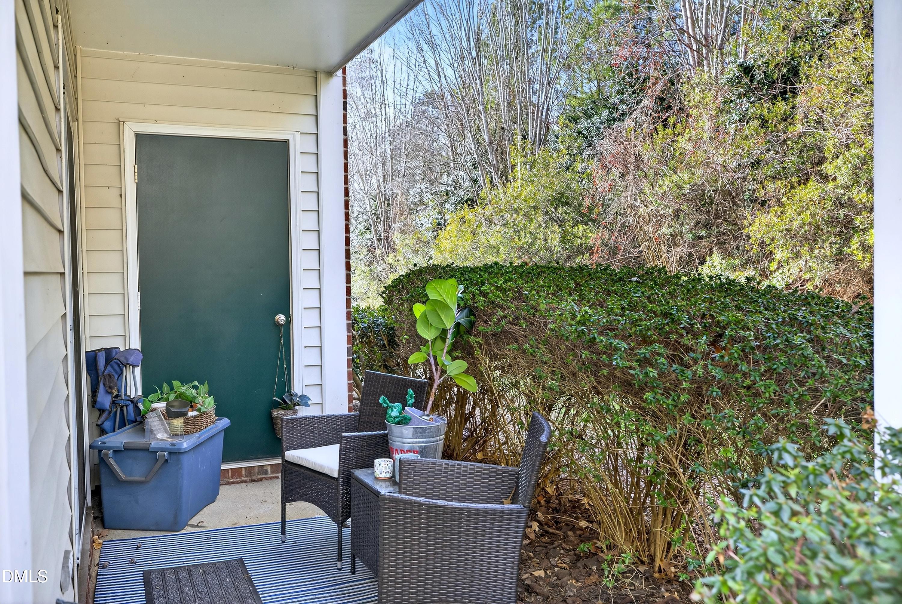 3413 Wellington Ridge Loop Cary, NC 27518 - Photo 3 of 12 a view of a balcony with chairs and potted plants