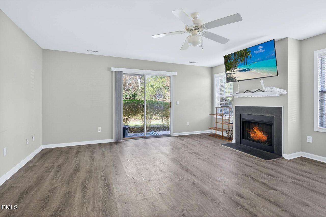 3413 Wellington Ridge Loop Cary, NC 27518 - Photo 8 of 12 a view of an empty room with a fireplace and a window