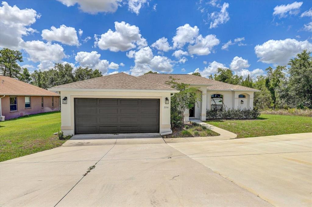 7314 Madrid Road Weeki Wachee, FL 34613 - Photo 36 of 54 a front view of house with yard