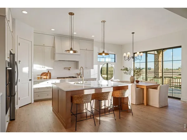 a kitchen with stainless steel appliances kitchen island granite countertop a sink and cabinets
