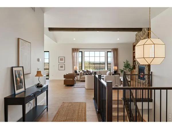 a living room with furniture a fireplace and a large window
