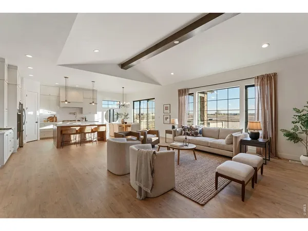 a living room with furniture a rug and a table