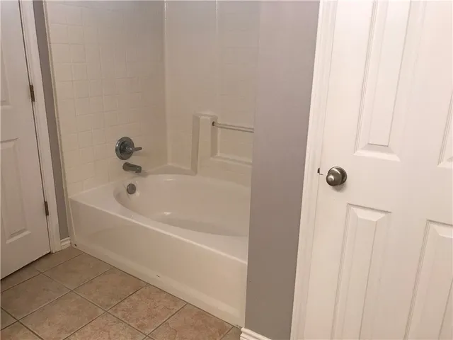 a white bath tub sitting next to a white sink