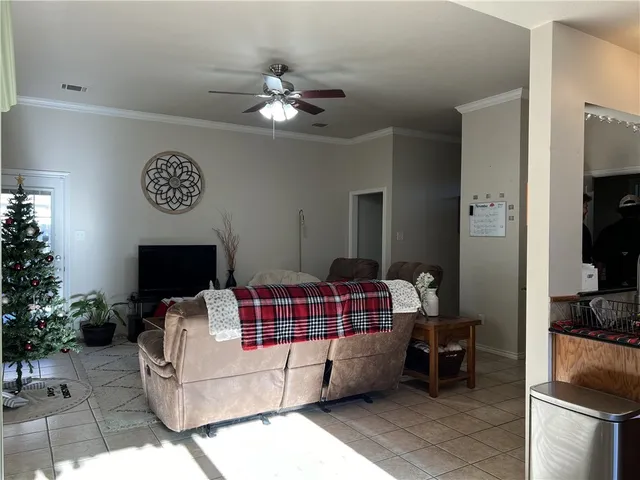 a living room with furniture and a flat screen tv