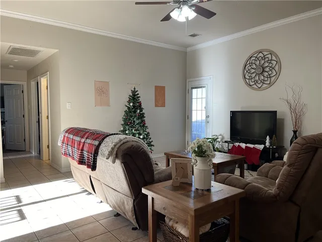 a living room with furniture and a flat screen tv