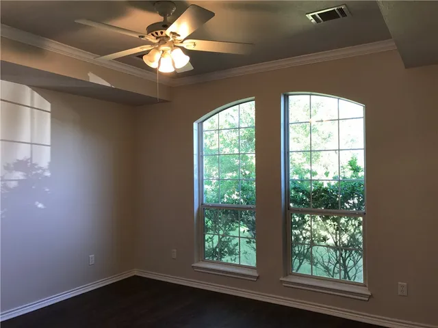 a view of a livingroom with a window and a ceiling fan